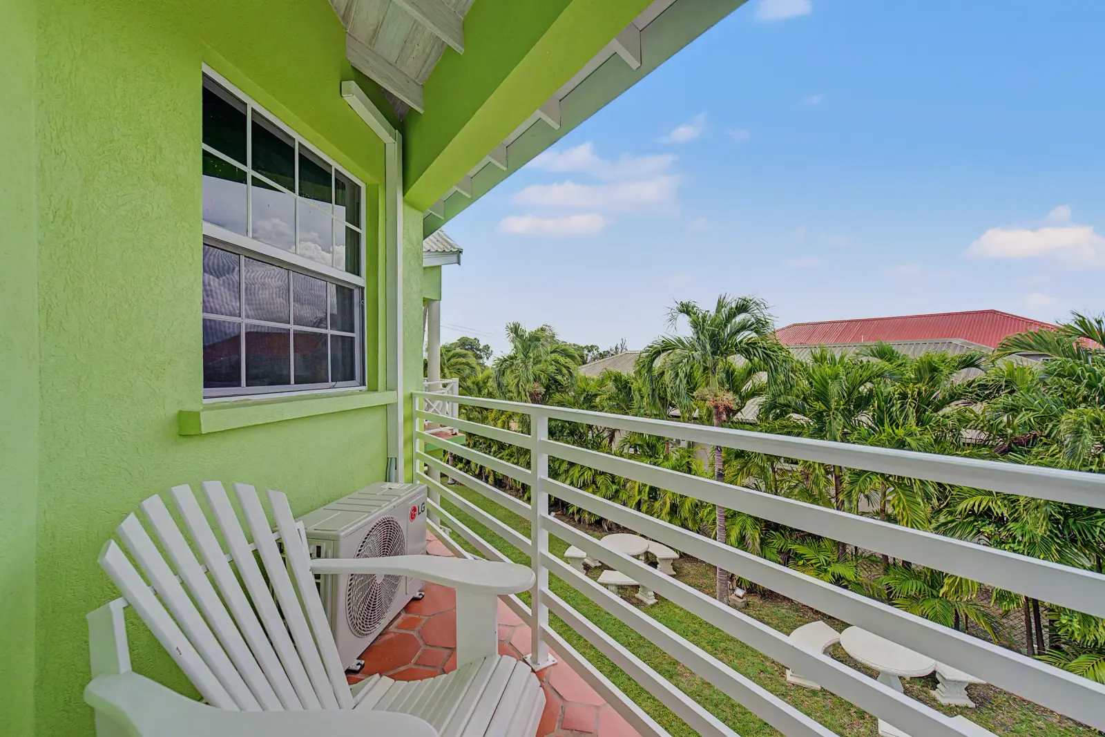 Private balcony looking over tropical palms at Best E Villas